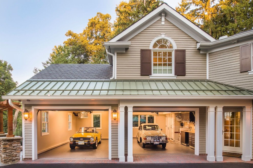 На фото: большой пристроенный гараж в классическом стиле для двух машин