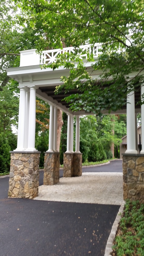 Photo of a large classic attached single port cochere in New York.