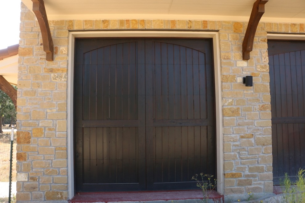 Design ideas for an expansive rustic attached double garage in Austin.