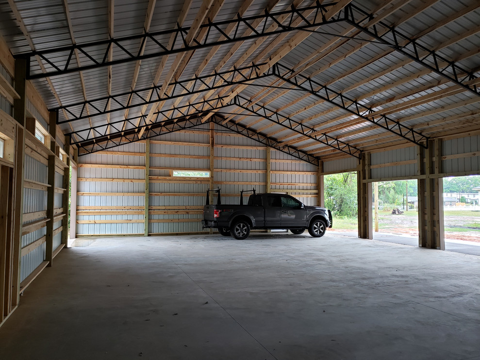 Photo of a medium sized farmhouse detached garage workshop in Other with three or more cars.