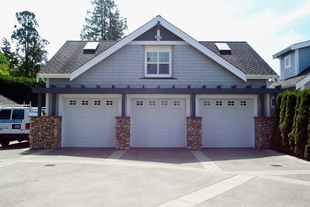 Example of a large arts and crafts detached three-car boathouse design in Seattle