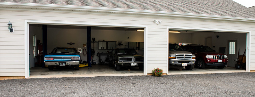 Inspiration for a large timeless attached three-car garage remodel in DC Metro