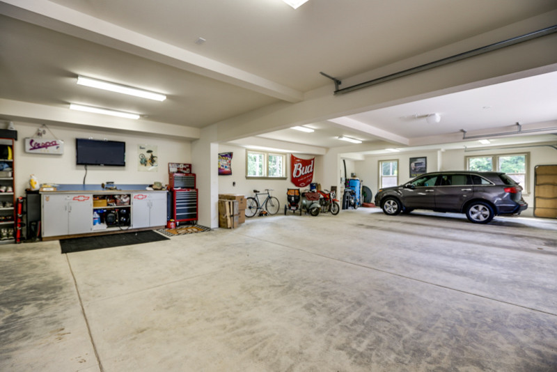 Inspiration for a huge timeless attached four-car garage workshop remodel in Portland