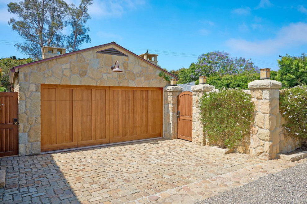 Inspiration for a small mediterranean attached two-car garage remodel in Santa Barbara