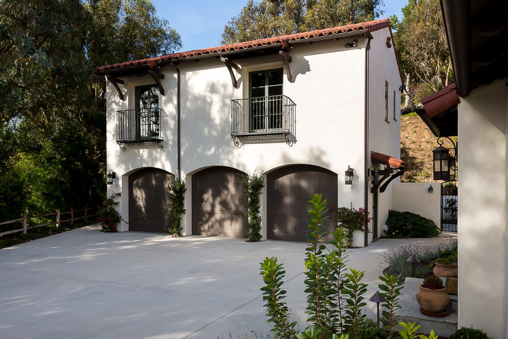 Photo of a mediterranean detached garage workshop in Los Angeles with three or more cars.