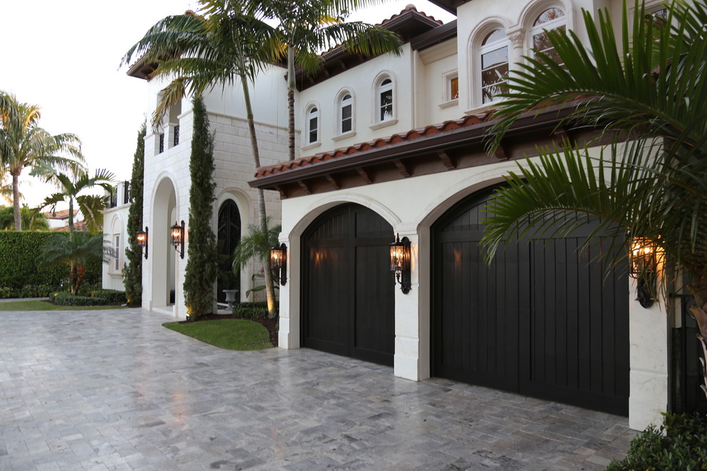 Design ideas for a large mediterranean attached double garage in Miami.
