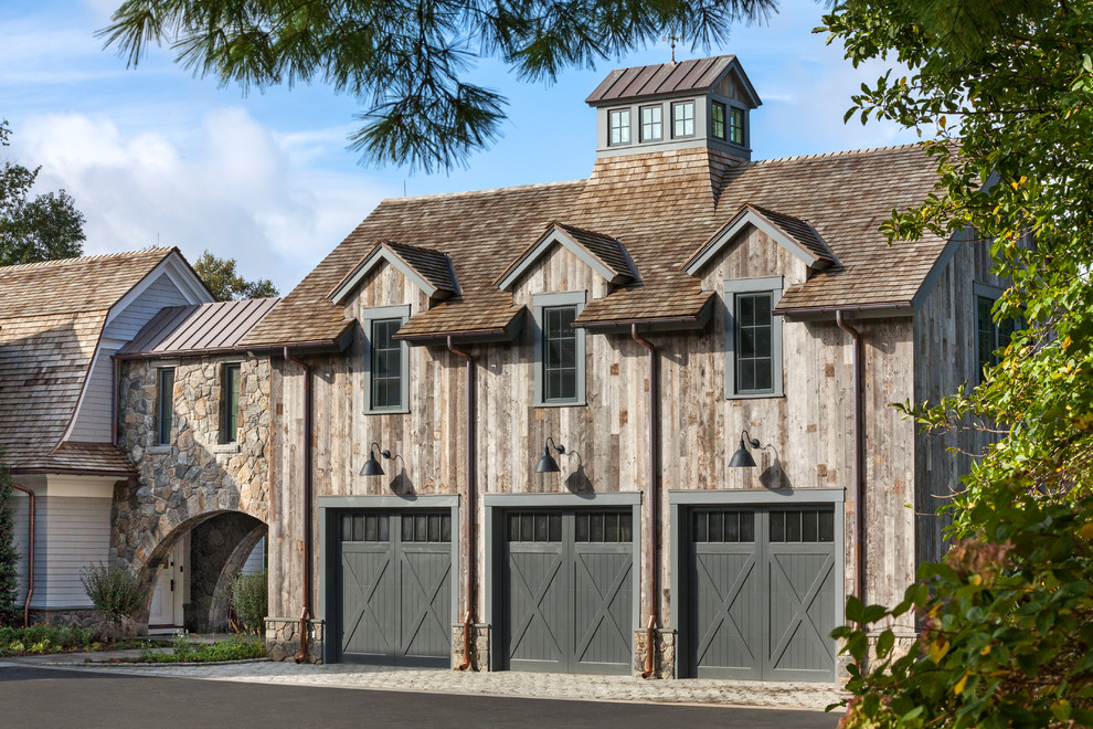 Inspiration for a cottage attached three-car garage remodel