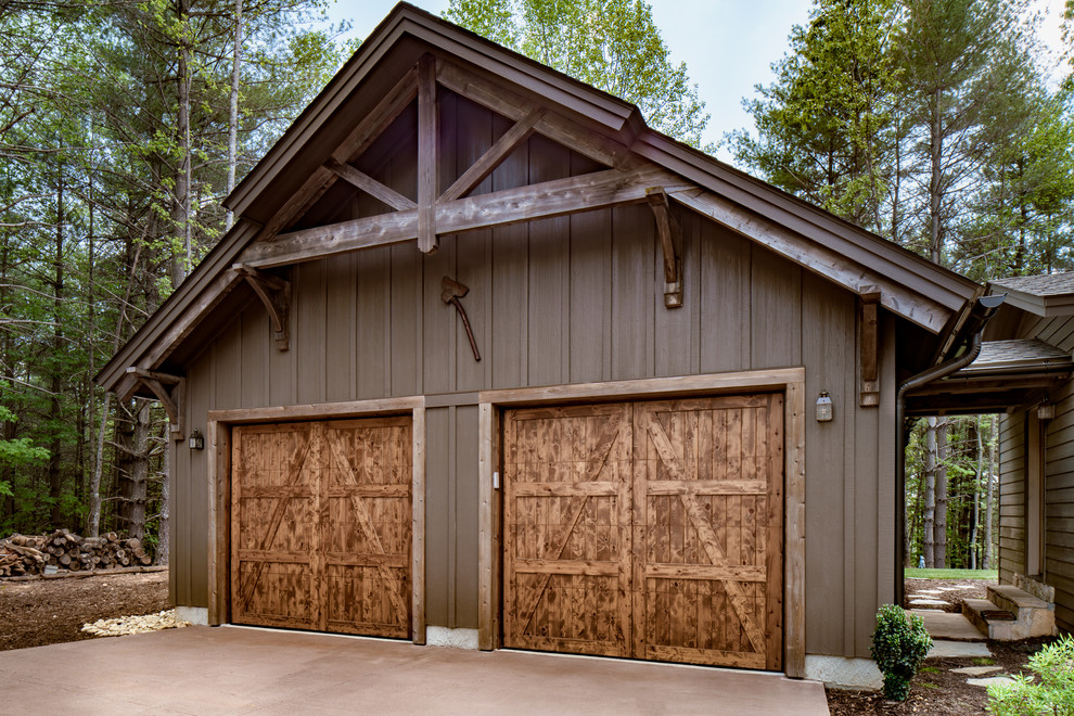 Example of a mid-sized mountain style detached two-car carport design in Other