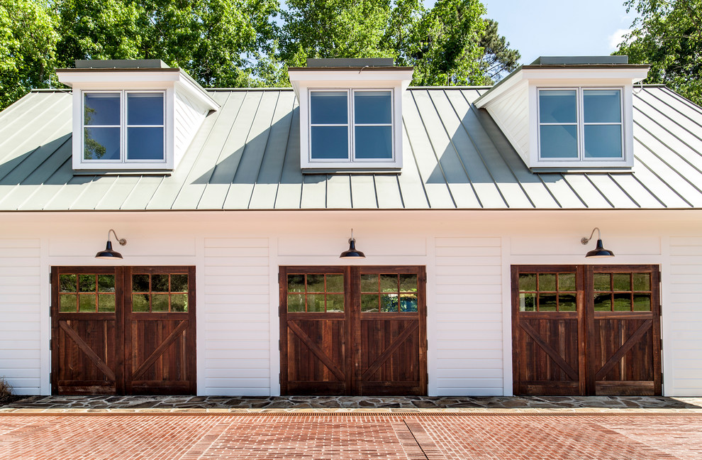 Garage - cottage detached three-car garage idea in Raleigh