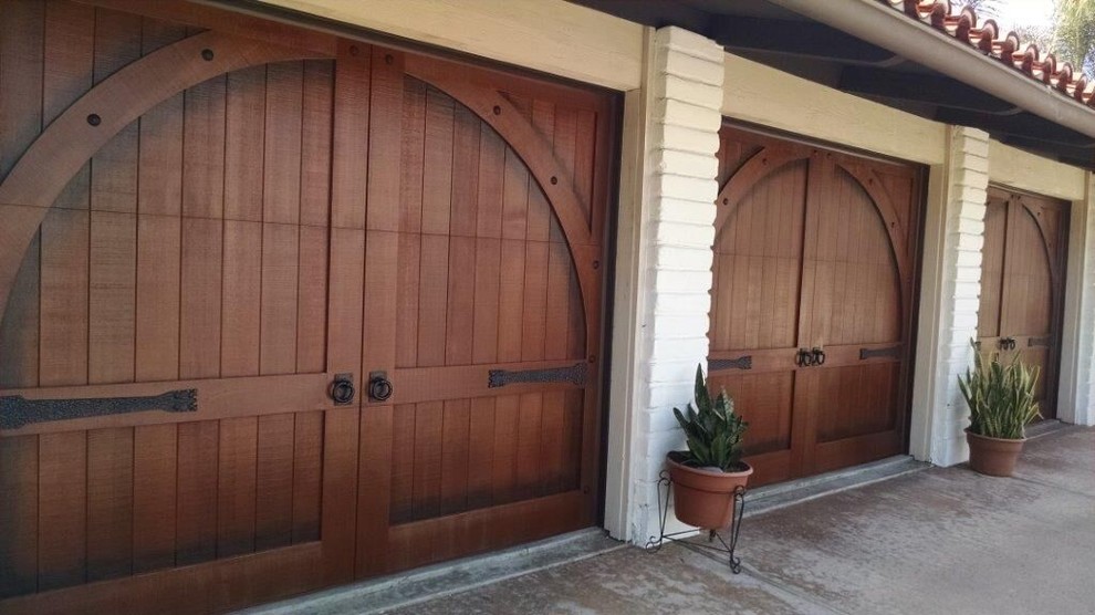 Inspiration for a large southwestern attached three-car garage remodel in Orange County