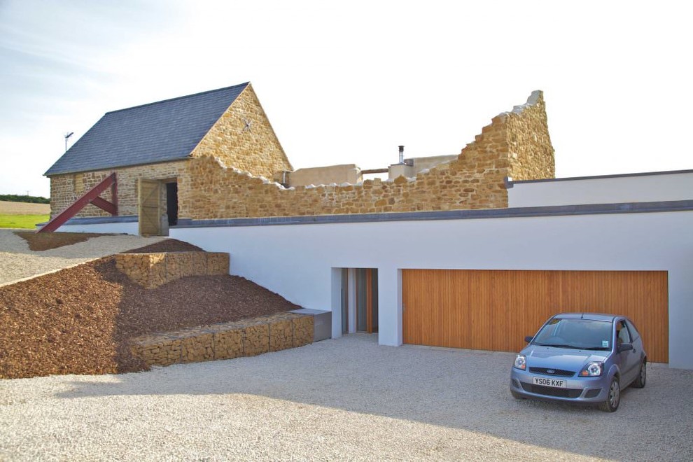 Пример оригинального дизайна: пристроенный гараж среднего размера в стиле модернизм для двух машин
