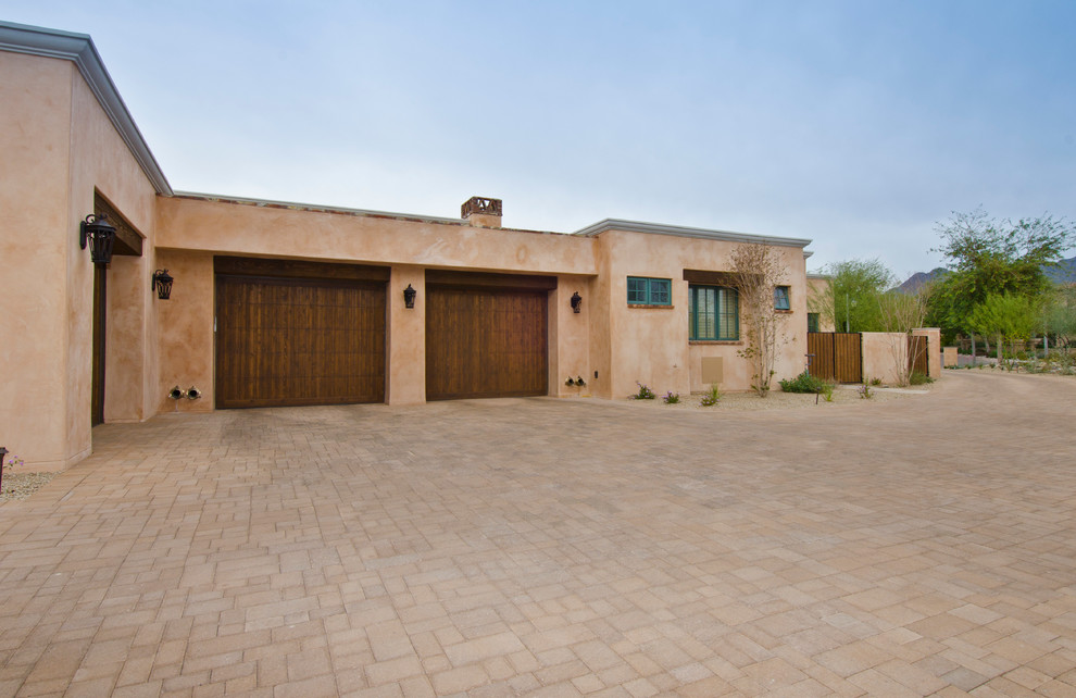 Mid-sized southwest attached three-car garage photo in Phoenix
