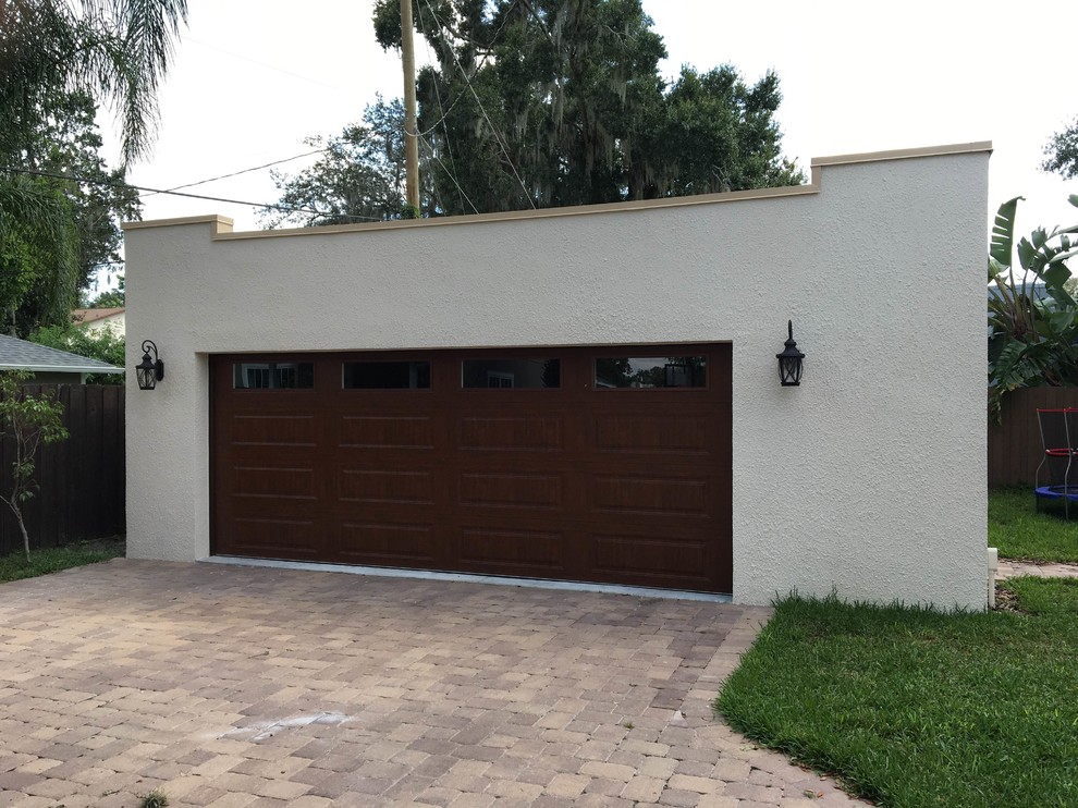 Example of a mid-sized tuscan detached two-car garage design in Orlando