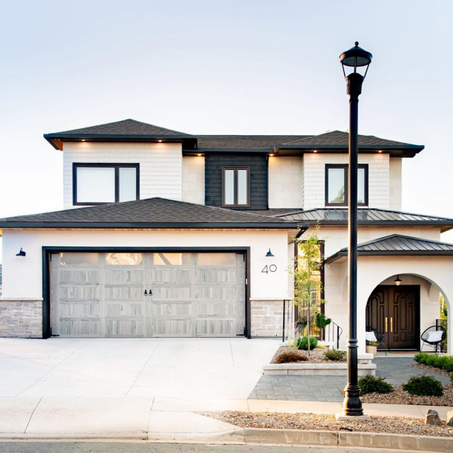 Real Estate Agent Showcasing House with Stamped Garage Doors