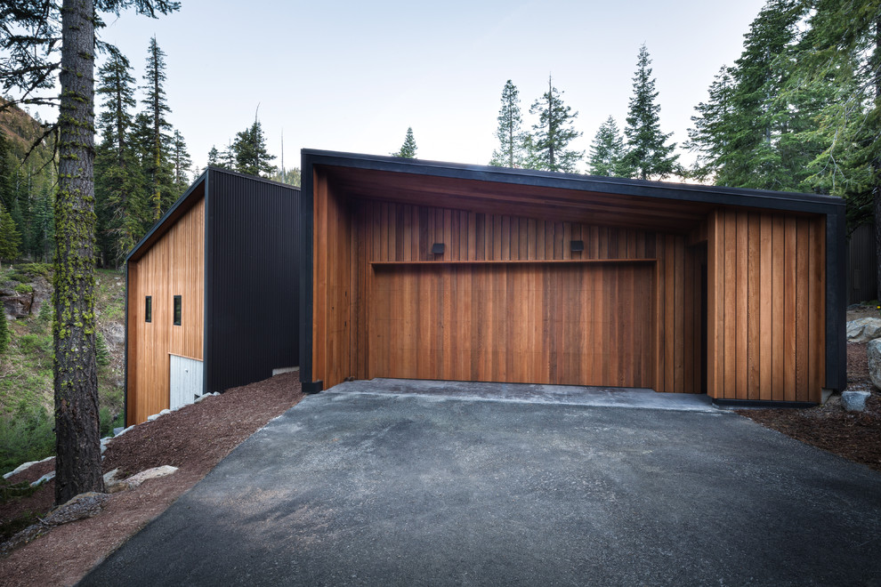 На фото: отдельно стоящий гараж в современном стиле для двух машин
