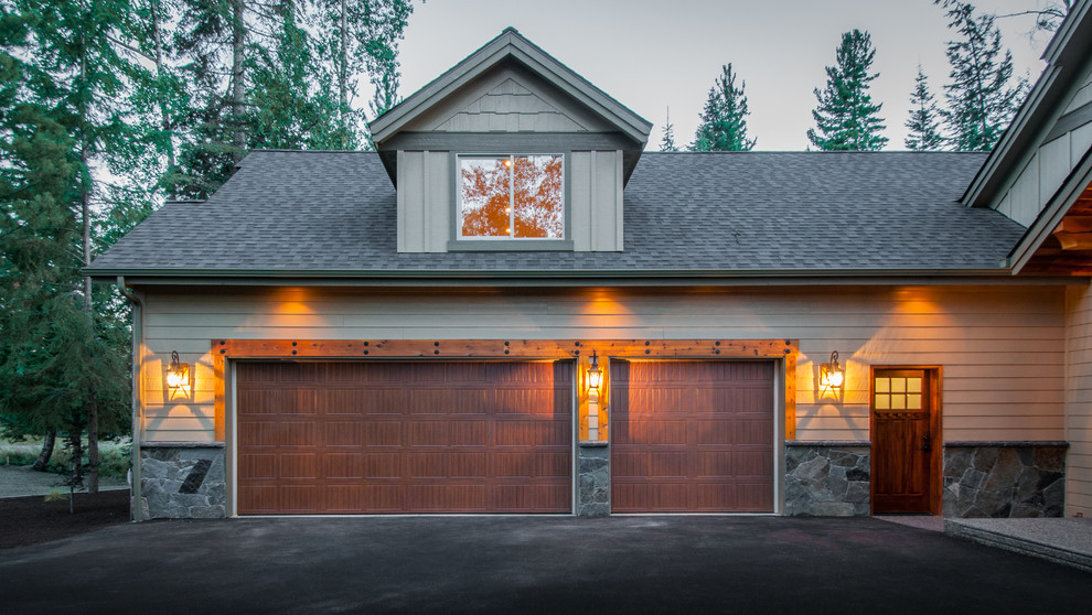 Example of a mid-sized arts and crafts attached three-car garage design in Seattle