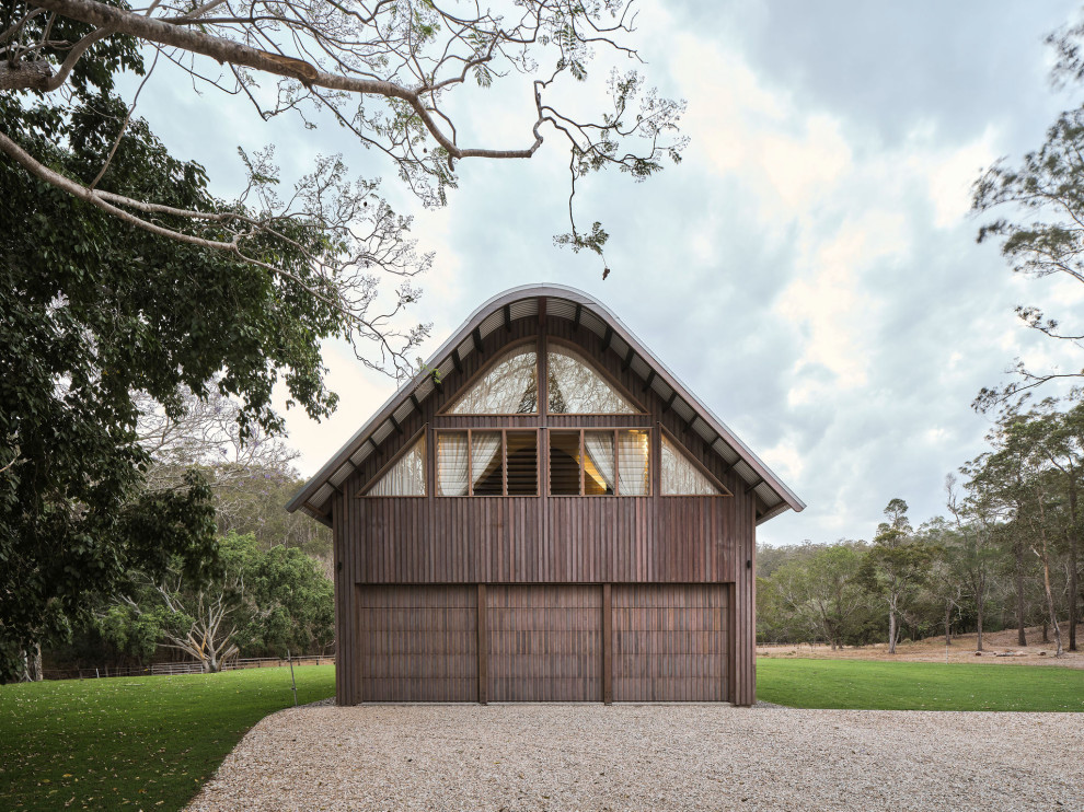 Inspiration for a mid-sized cottage attached three-car garage remodel in Brisbane