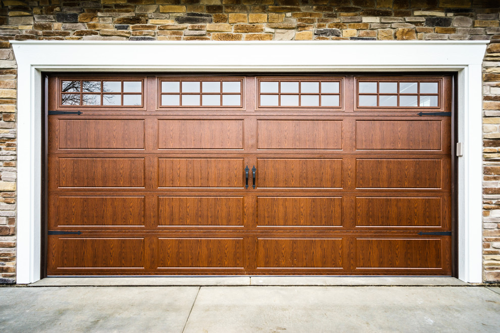 Design ideas for a medium sized traditional attached garage in Chicago with three or more cars.