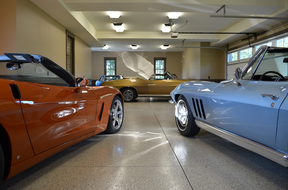 Example of a large eclectic attached three-car garage design in Charlotte