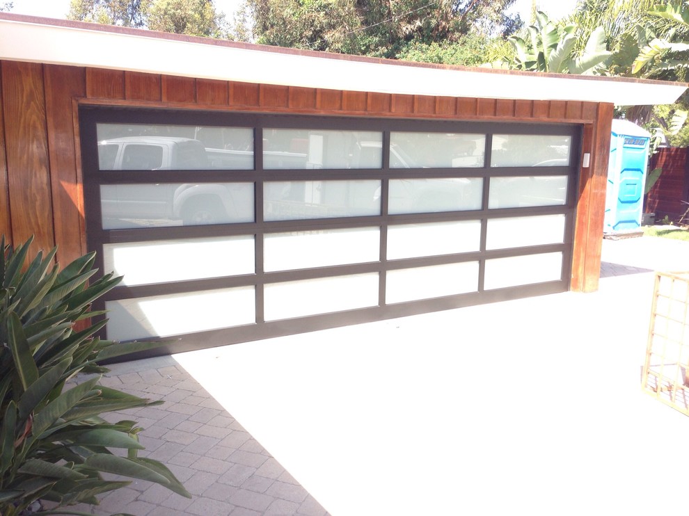 Inspiration for a mid-sized modern attached two-car garage remodel in Orange County
