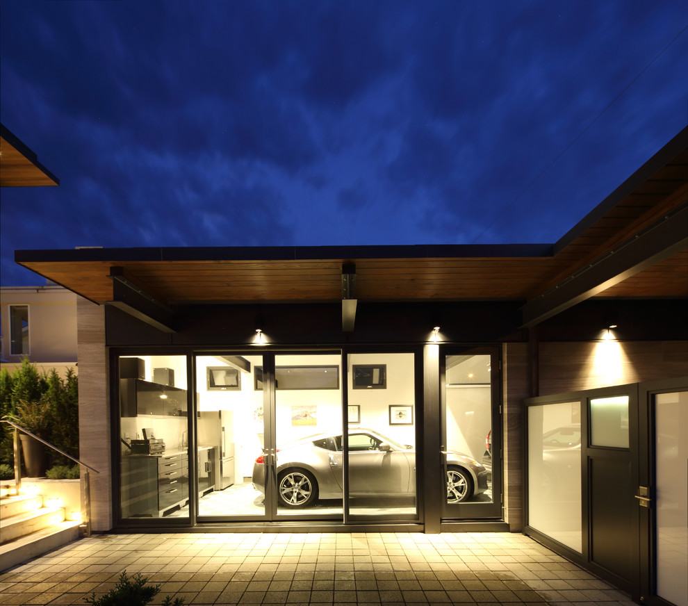 На фото: маленький отдельно стоящий гараж в современном стиле для на участке и в саду, двух машин с