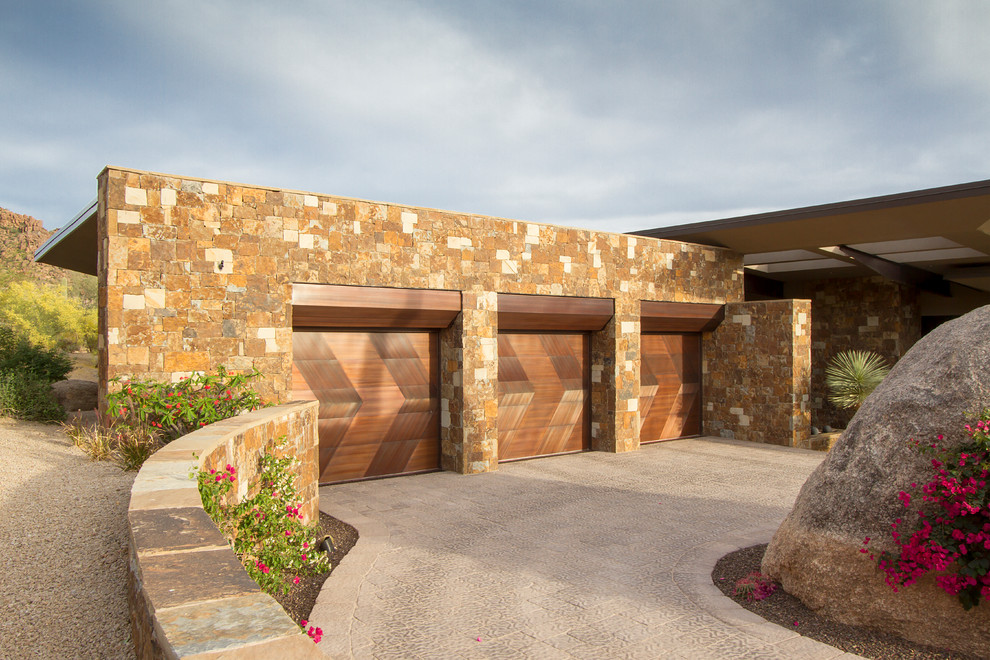 Inspiration for a contemporary three-car garage remodel in Phoenix
