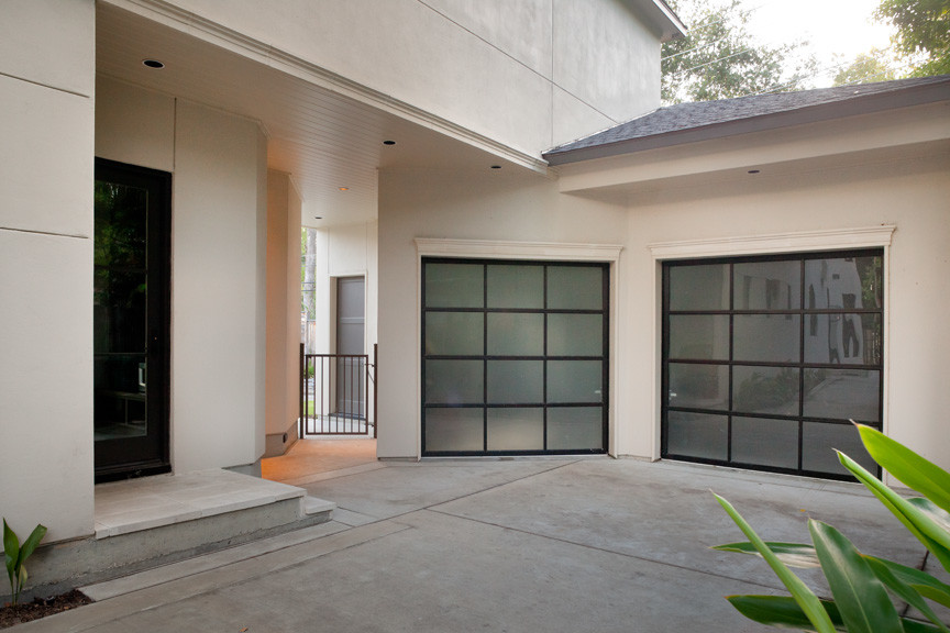 Mid-sized transitional attached two-car garage photo in Houston