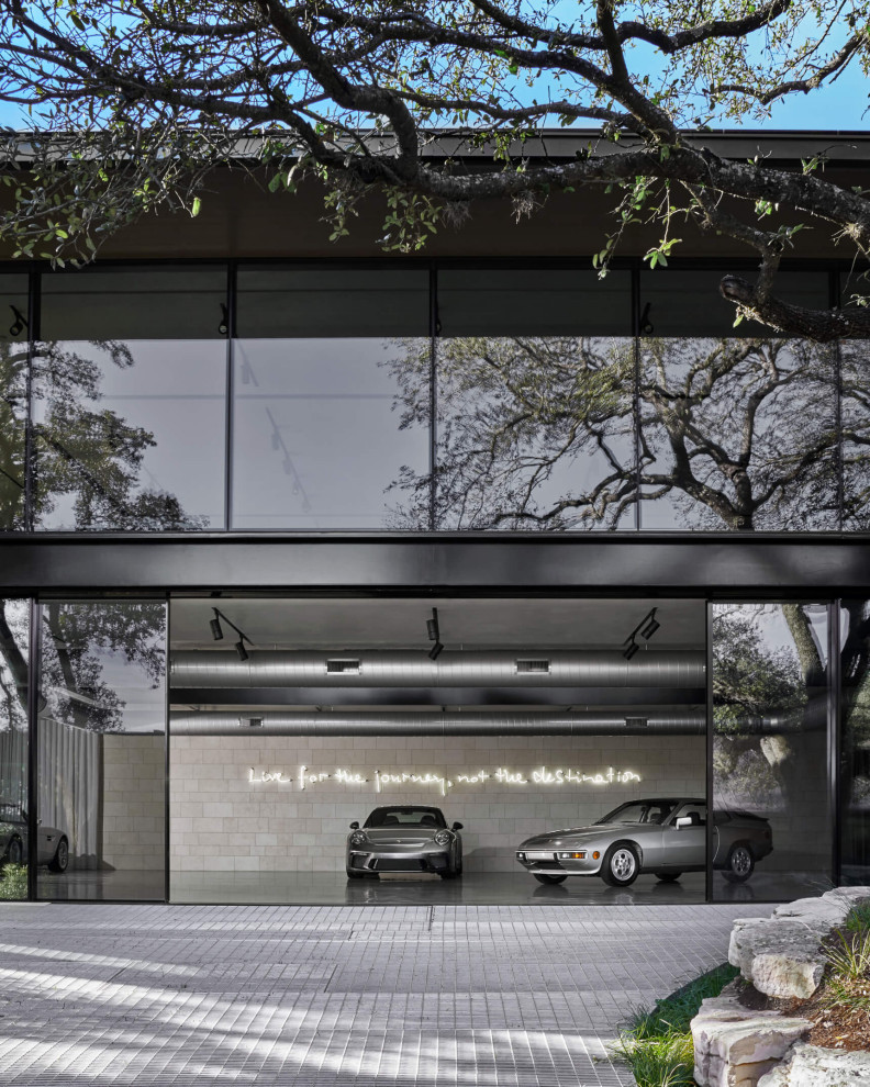 Example of a huge minimalist detached four-car garage design in Austin