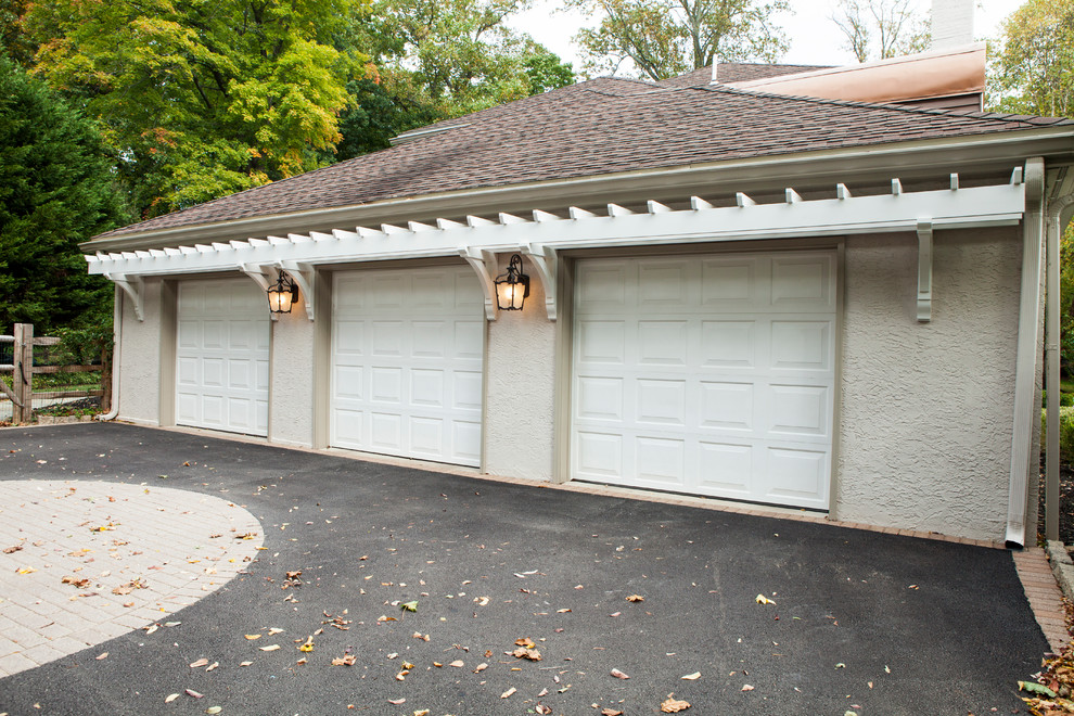 Example of a huge classic attached three-car garage design in Philadelphia