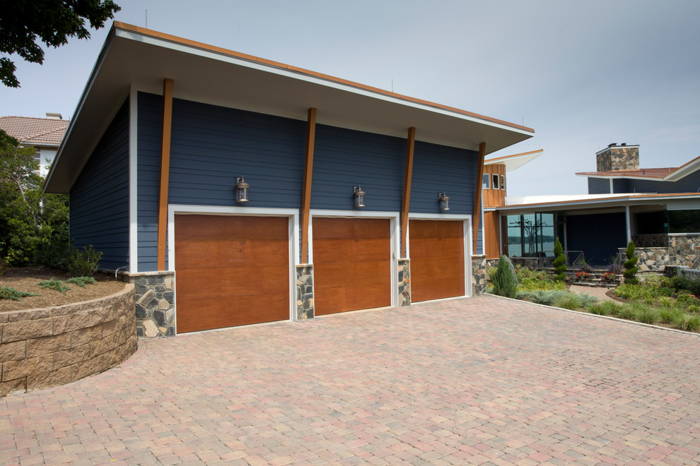This is an example of a contemporary garage in Charlotte with three or more cars.