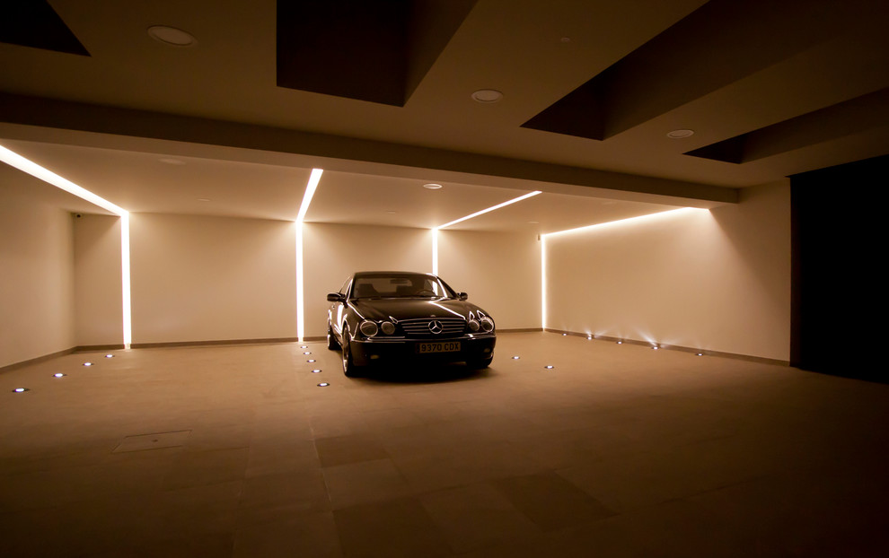 Example of a large minimalist four-car garage design in Other