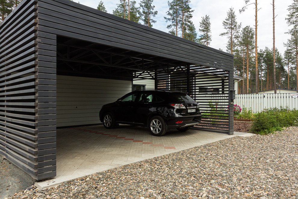 Пример оригинального дизайна: отдельно стоящий гараж в современном стиле с навесом для автомобилей для двух машин