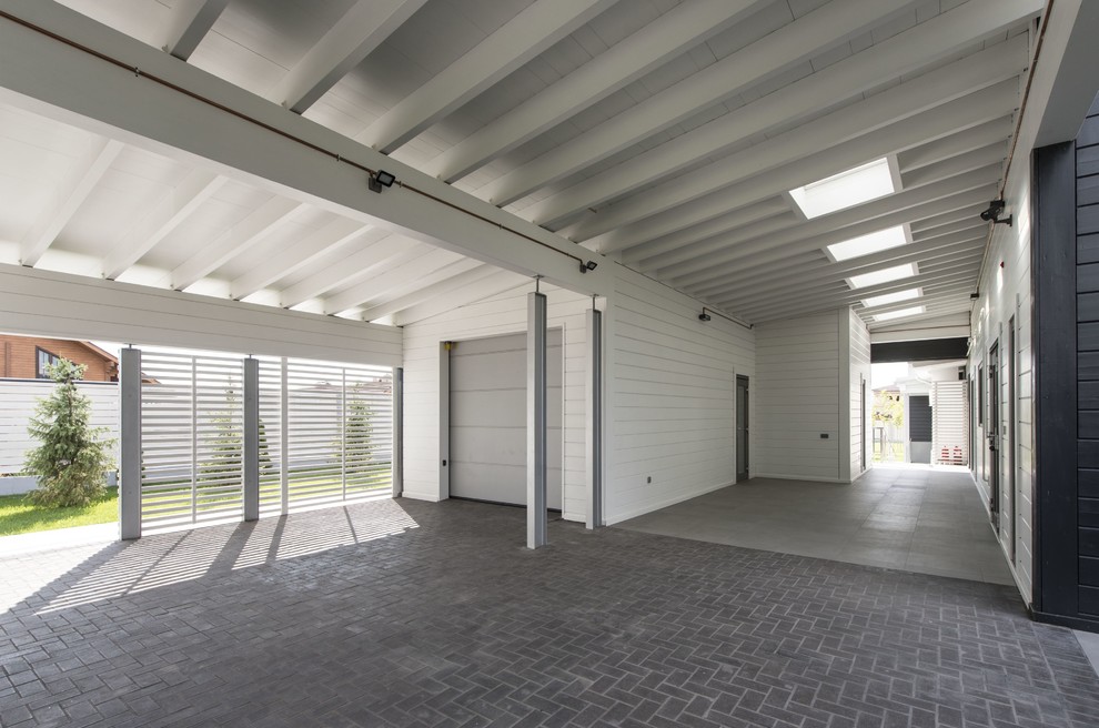 Exempel på en mellanstor modern garage och förråd