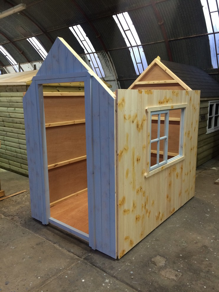 This is an example of a medium sized modern detached garden shed in Other.