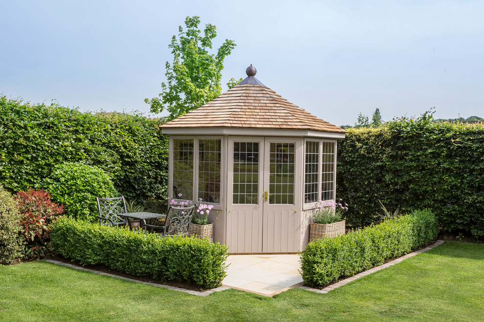 This is an example of a medium sized classic detached garden shed and building in Other.