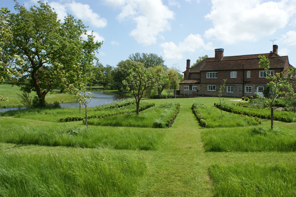 Design ideas for a huge farmhouse full sun landscaping in Sussex.