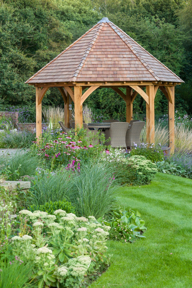 Idées déco pour un jardin arrière campagne de taille moyenne et l'été avec une exposition ensoleillée et des pavés en pierre naturelle.