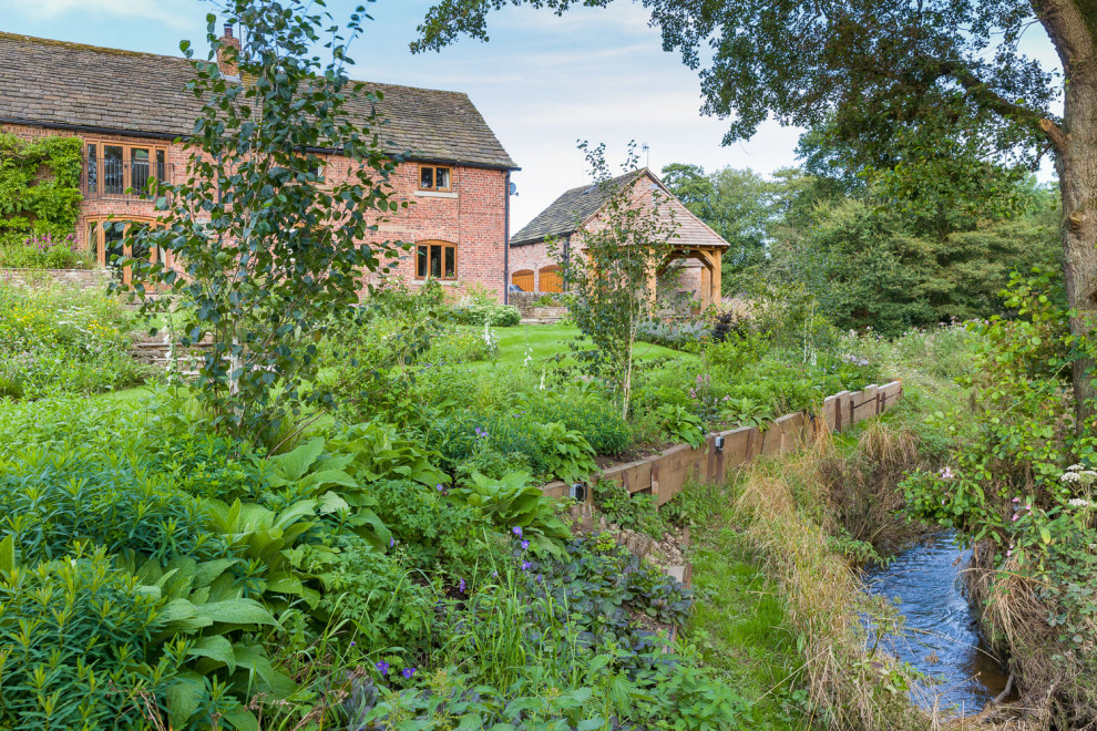 Immagine di un giardino country esposto in pieno sole di medie dimensioni e dietro casa in estate con pavimentazioni in pietra naturale