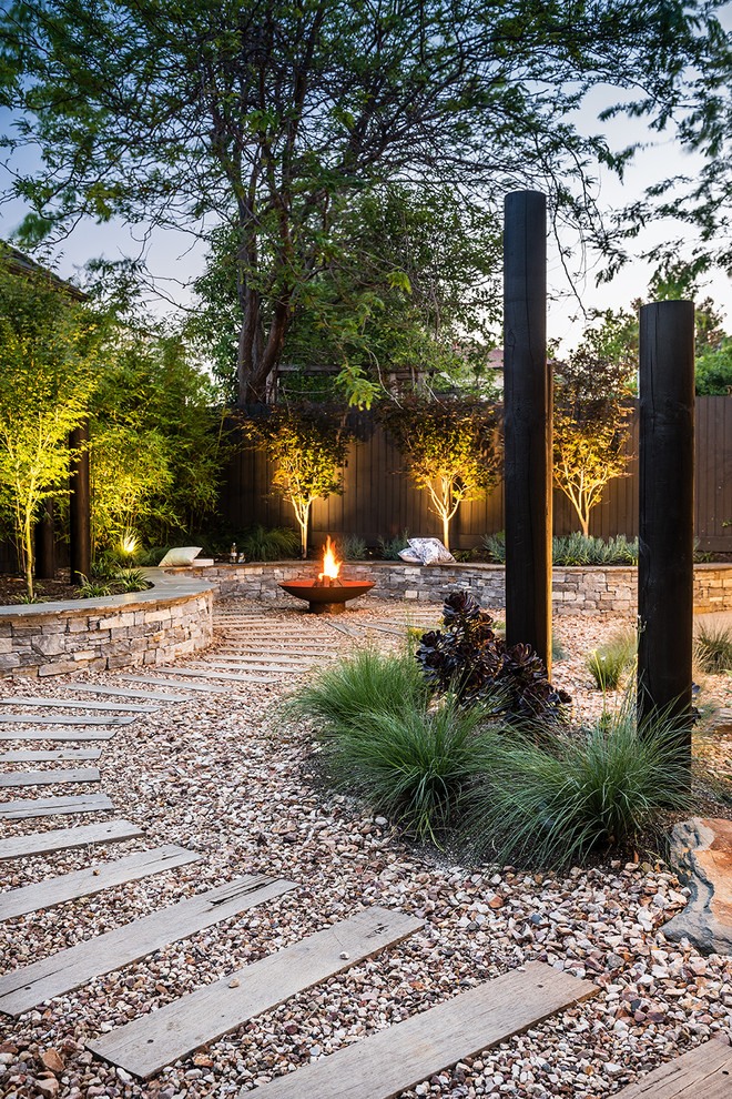 This is an example of a large contemporary backyard landscaping in Melbourne.