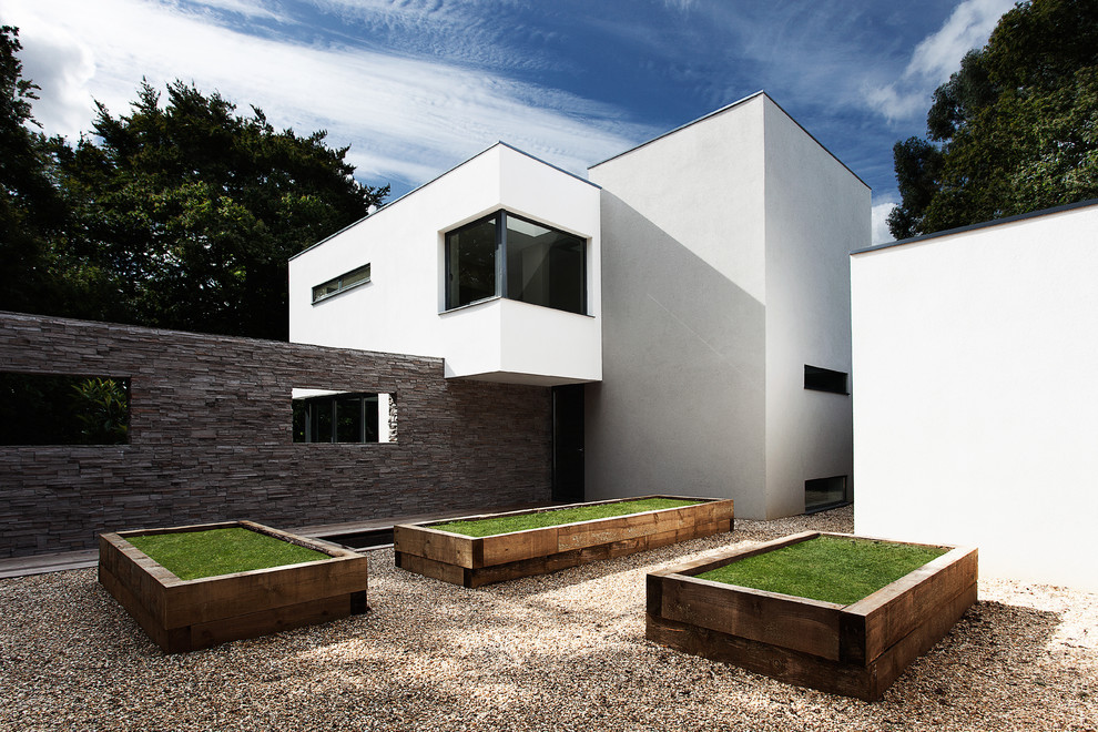 This is an example of a modern garden in Hampshire with gravel.