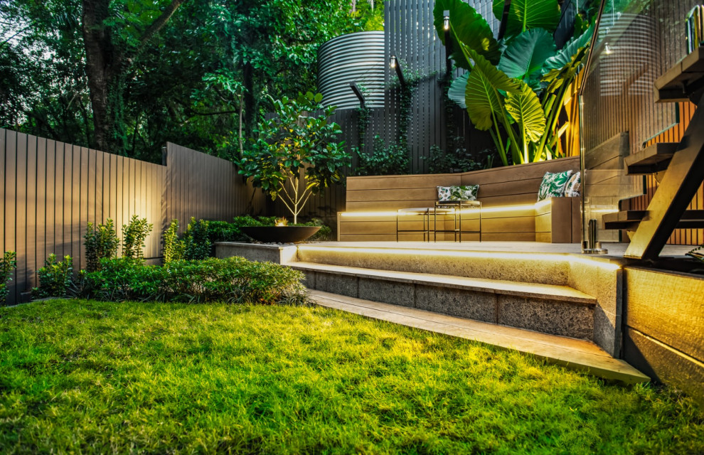 Photo of a small contemporary partial sun courtyard stone formal garden in Brisbane with a fire pit for summer.