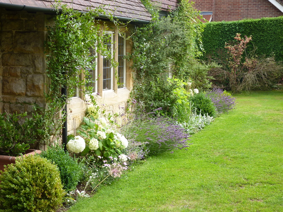 Design ideas for a medium sized farmhouse front formal garden for summer in Dorset.