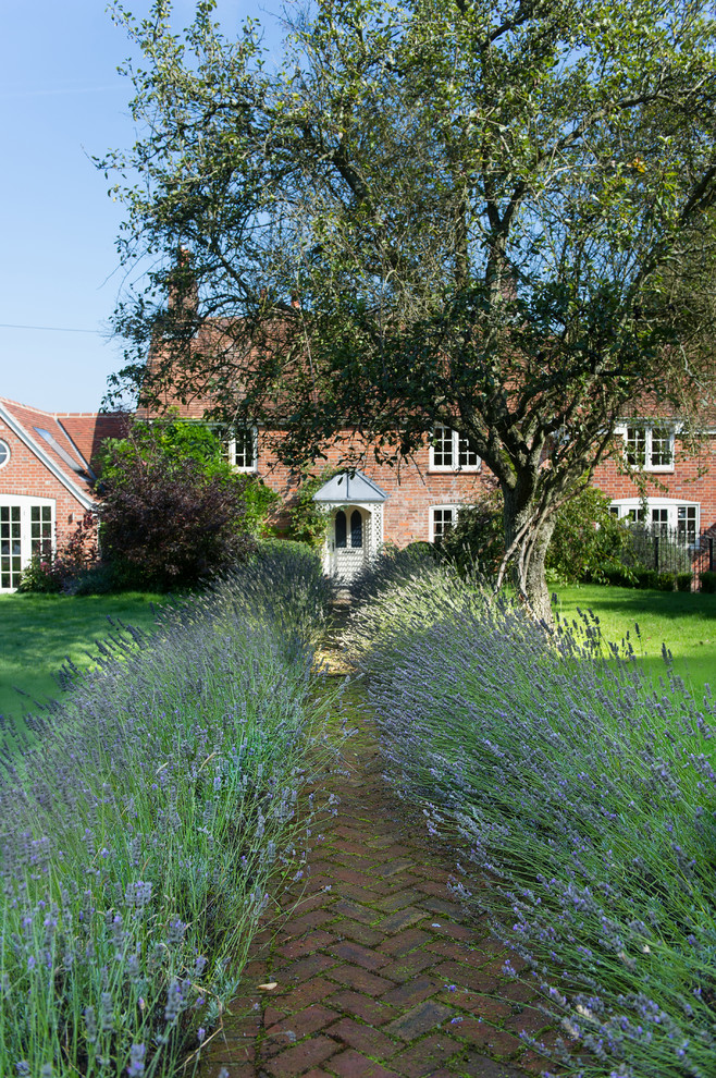 Photo of a farmhouse partial sun garden in Berkshire with a garden path and brick paving.