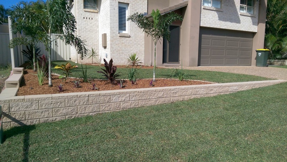 This is an example of a world-inspired front full sun garden in Gold Coast - Tweed with mulch.
