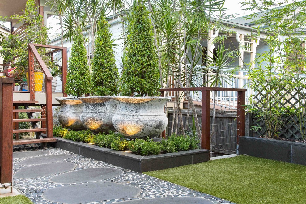 Inspiration for a contemporary front partial sun garden for summer in Brisbane with a garden path and concrete paving.