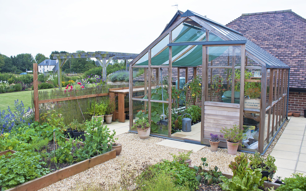 Inspiration for a mid-sized farmhouse full sun backyard gravel vegetable garden landscape in Other for summer.
