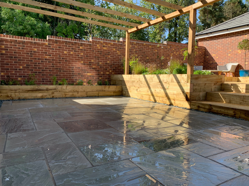Inspiration for a medium sized mediterranean back formal full sun garden for summer in Buckinghamshire with a pathway, natural stone paving and a wood fence.