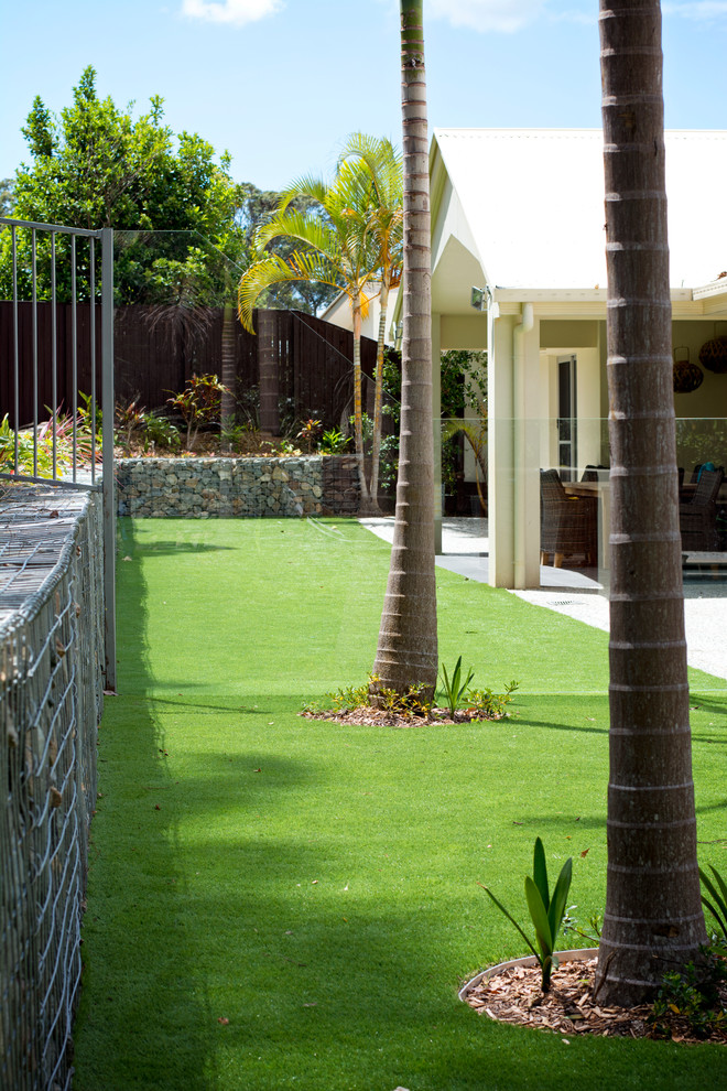 Идея дизайна: участок и сад среднего размера на заднем дворе в стиле модернизм с подпорной стенкой и полуденной тенью