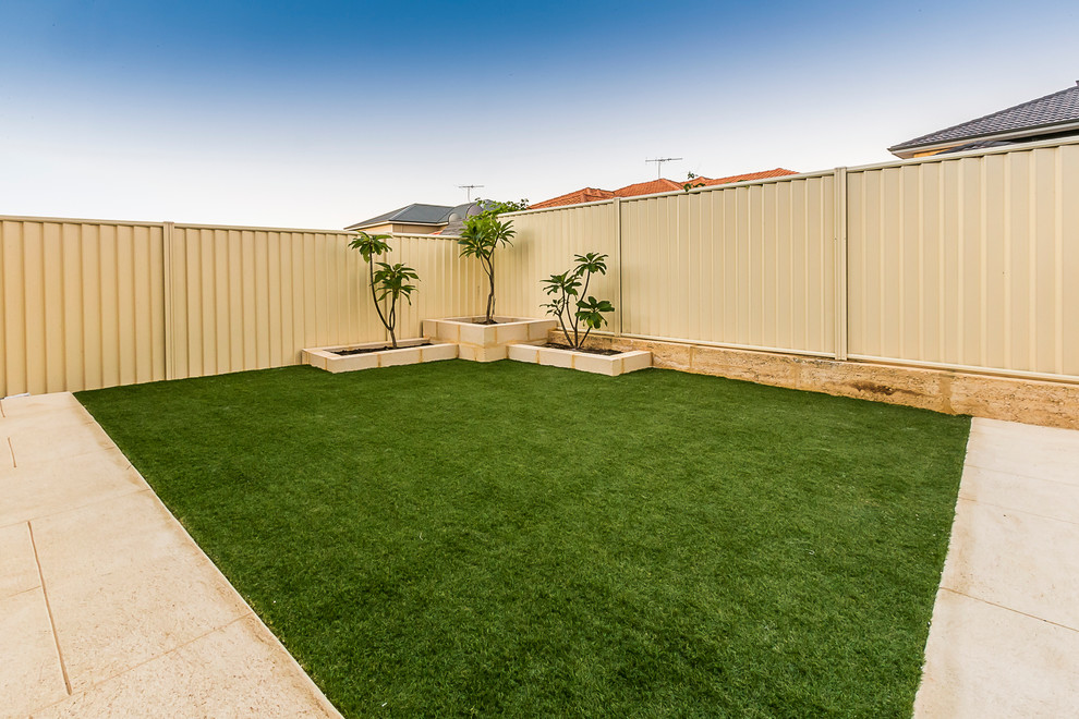 This is an example of a medium sized contemporary back full sun garden in Perth.