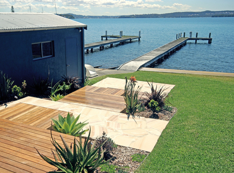 This is an example of a beach style full sun garden in Newcastle - Maitland with decking.